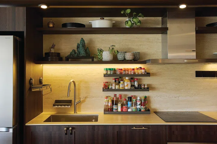 Dark laminate kitchen cabinets in a 3-bedroom condo (1,800 sq ft) in Pandan Valley, designed by Insight.Out Studio.