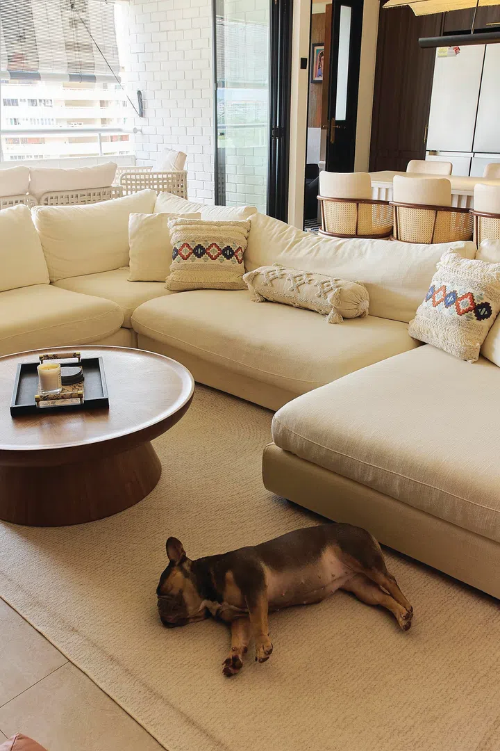 An off-white, plush L-shaped sofa in a 3-bedroom condo (1,800 sq ft) in Pandan Valley, designed by Insight.Out Studio.