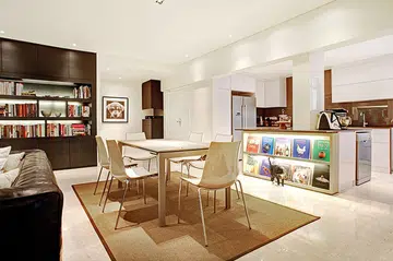 An inviting open-plan kitchen and dining area greets this home’s guests as they step through the front door.
