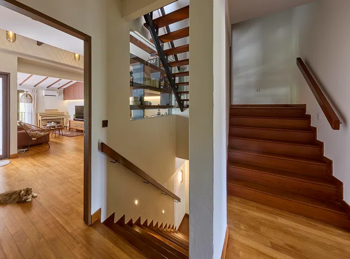 A split-level transition leads from the main living areas to the upper floors, setting up a gradual shift from public to private spaces.