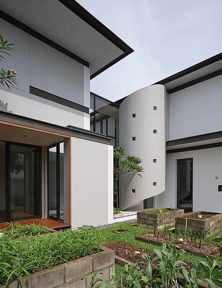 At the rear is a vegetable garden, farmed just adjacent to one of the home’s sculptural elements — its cylindrical second staircase. (Photo: Fabian Ong)
