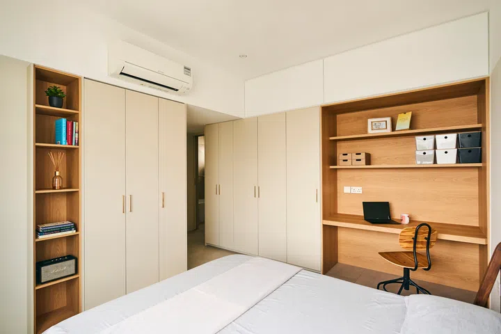 A wood-like laminate decks the full-height carpentry in the master bedroom.