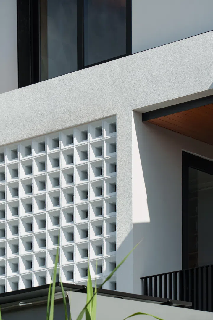 The geometric breeze block façade gives the home its architectural identity while supporting the privacy brief.