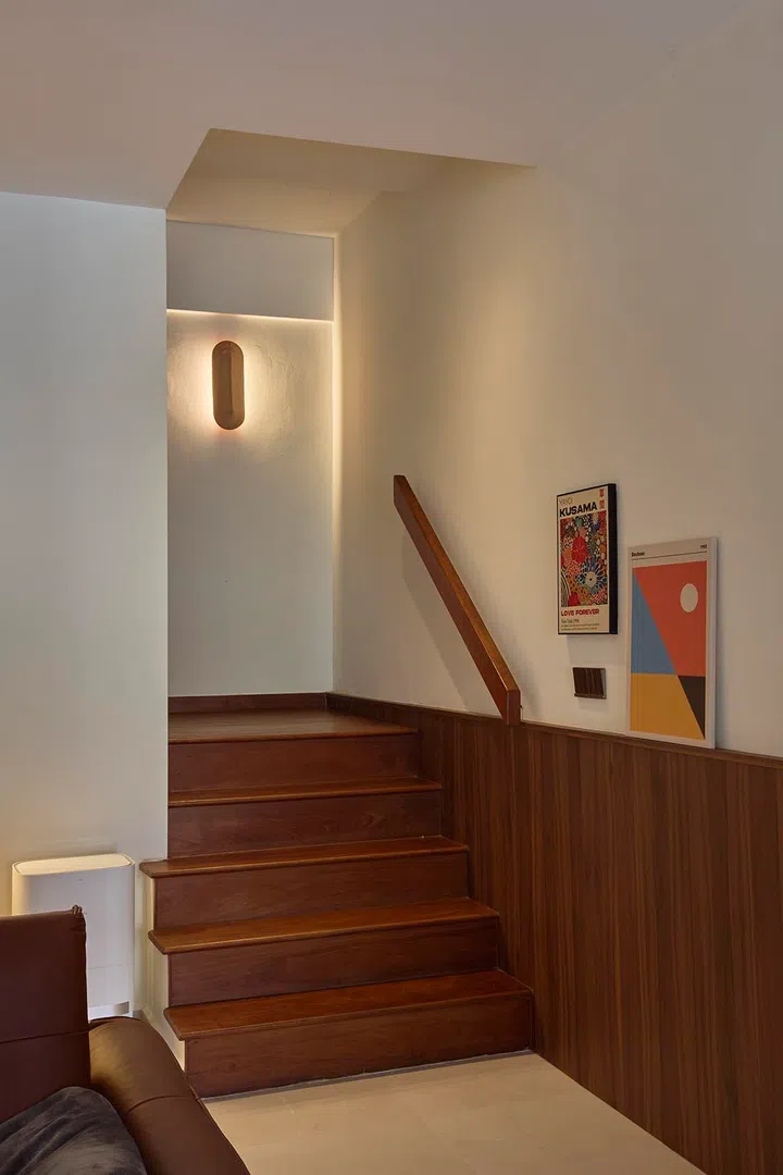 The original staircase is retained and refinished, with timber treads softening its metal structure.