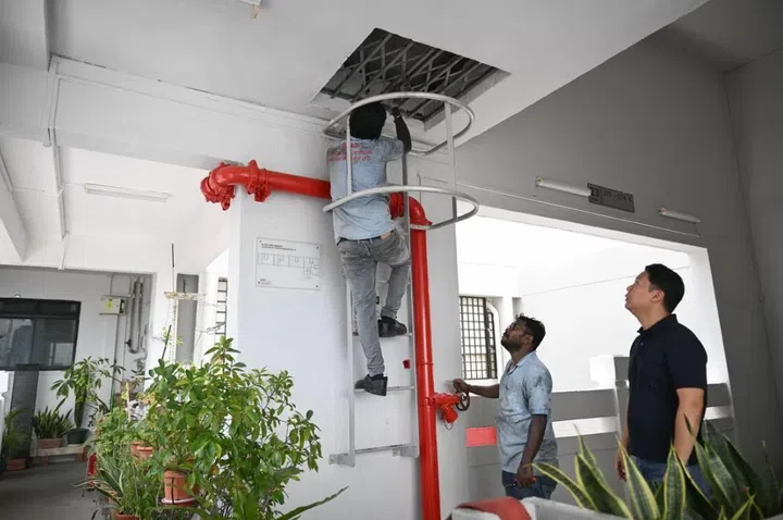 Work being carried out at Block 269B Queen Street on March 20, after a blackout hit the block.
