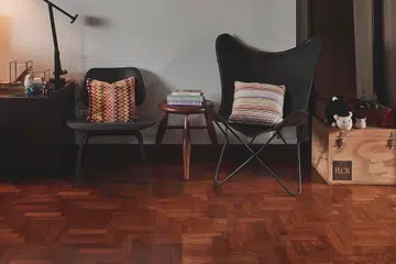 A slant of a wooden butterfly stool here, a solid brown leather back of a real Acanto there…