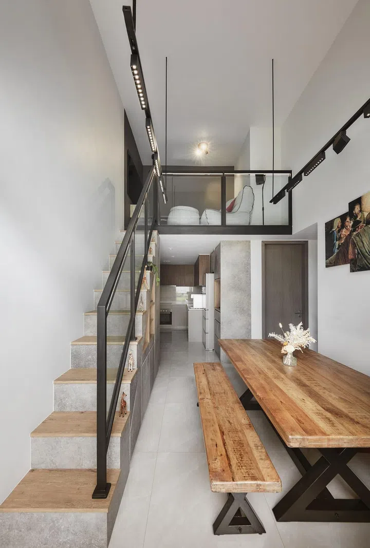 Loft living room above kitchen and wooden dining room table