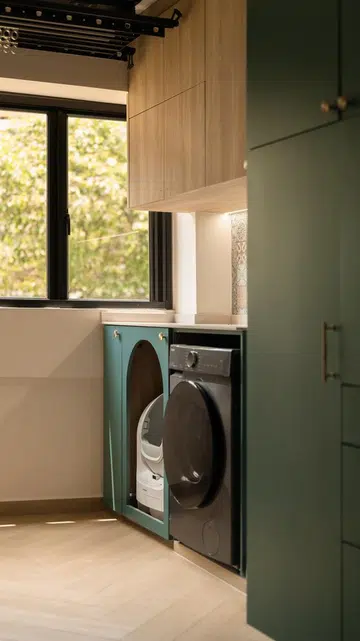 The generous service yard continues the same material palette, with custom cabinetry concealing Tommy’s automated litter box while providing dedicated laundry space.