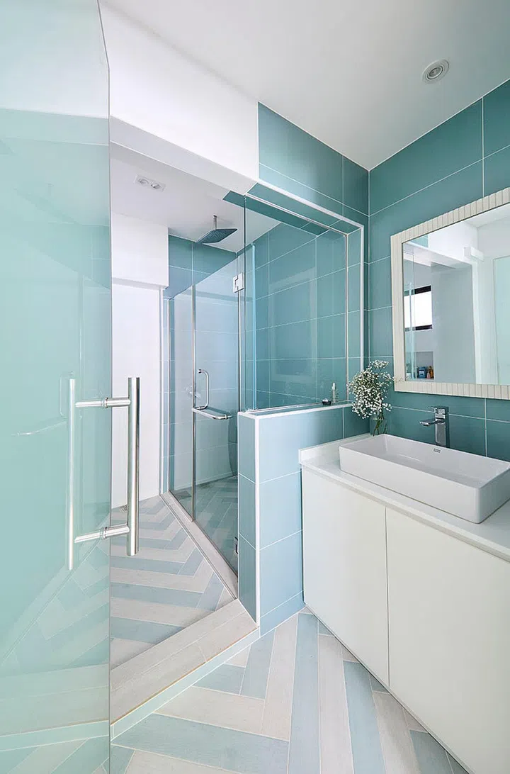 The master bedroom's interior design style spills into the en suite master bathroom with lighter shades of blue on some walls and white on the rest.