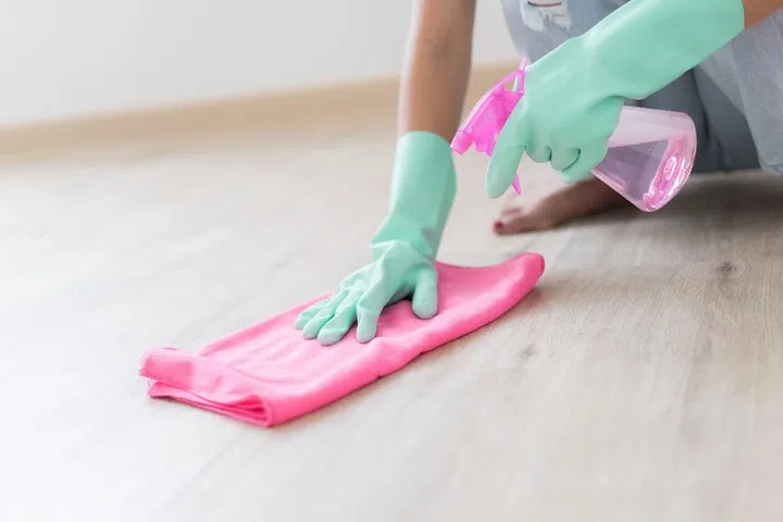 Asian woman cleaning the floor in the living room