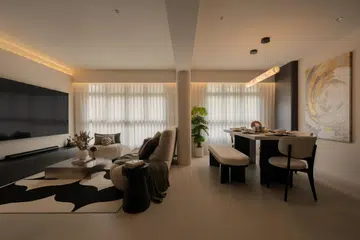 An open-plan living and dining area softened by curves, warm lighting, and a neutral palette designed for hosting and daily living.