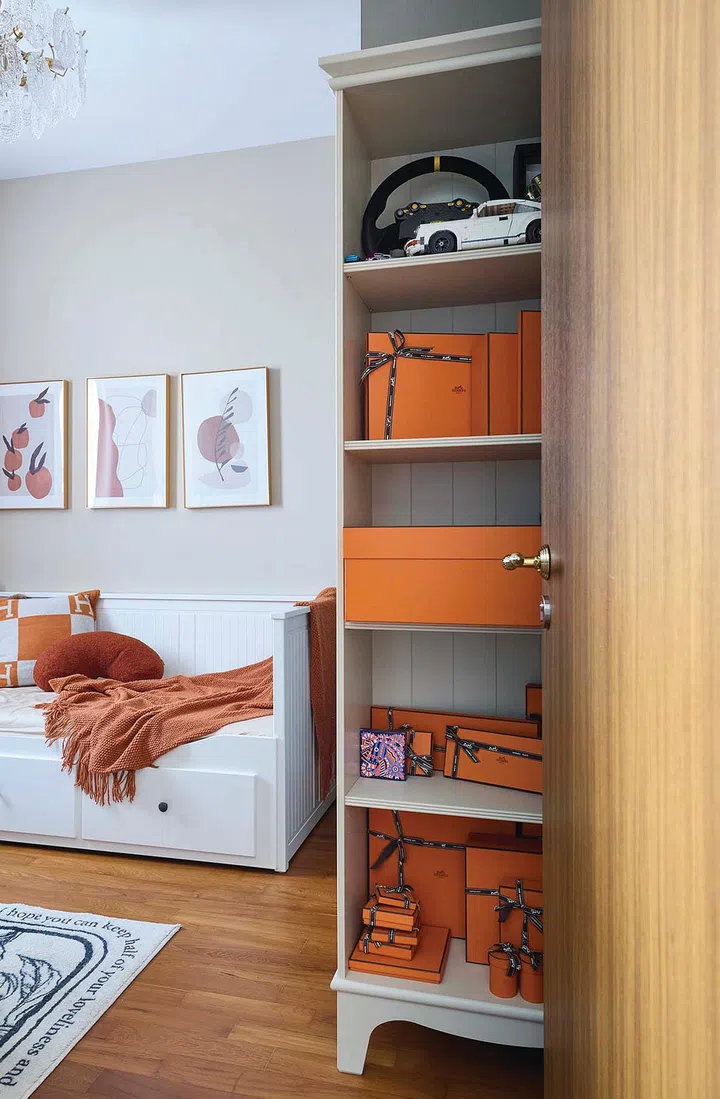 Terracotta brown throws and cushions line the guest bed, while a tower of signature Hermes boxes are displayed neatly on a shelf in interior designer Vivian Chen (of Muwu Construction) and financial advisor husband, Michael Chan's 635 sq ft 2-bedroom condominium along Stirling Road.