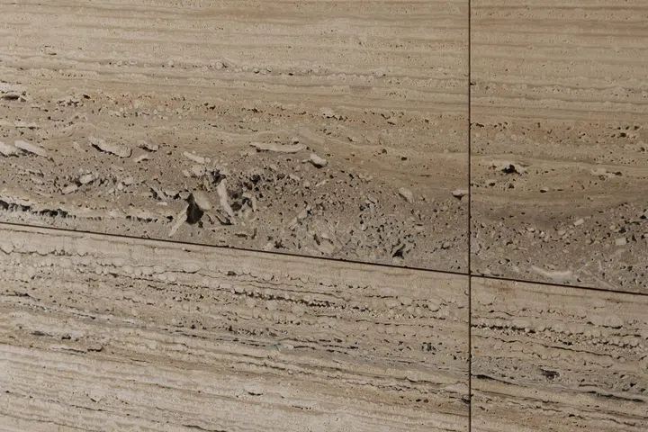 Close up of a travertine wall with the micro cavities deliberately left unfilled in a 6,534 sq ft semi-detached at Jalan Belibas, Upper Thomson designed by Metre Architects.