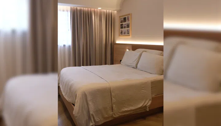Master bedroom in interior designer Cedrick Law and wife Chua Tse Lyn's 4-room HDB resale flat in Bedok.