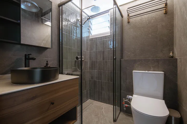 Inspired by boutique hotels, the guest bathroom was designed by John and is noticeably moodier. 