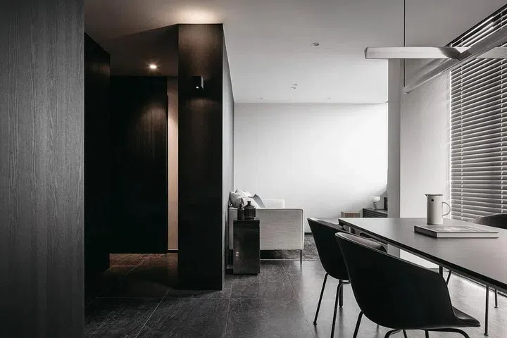 Lighter tones on walls and furniture maintain a balance with the darker finishes.