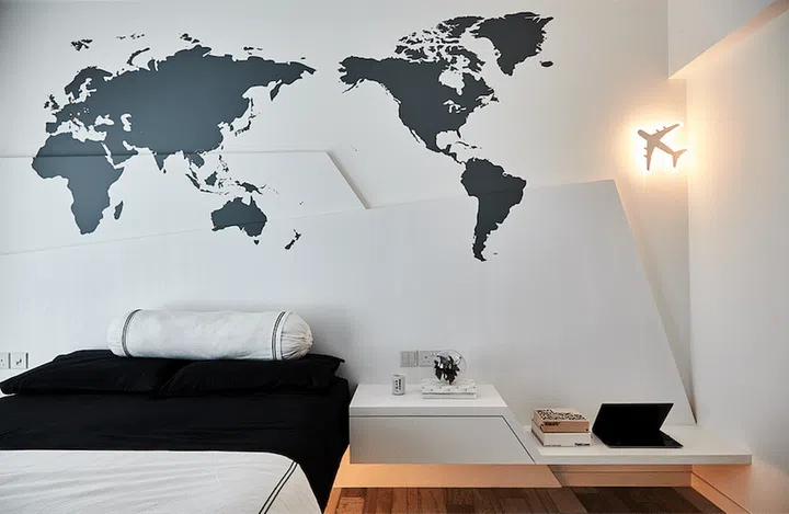 In the bedroom of this industrial New York loft style 3-room HDB BTO in Punggol, the interior design was kept simple, except for a print of the world map and an airplane night light that decorates the wall.