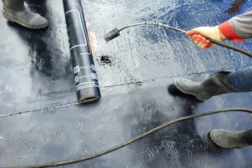 Professional installation of waterproofing on the concrete foundation Two worker at construction site. 2019