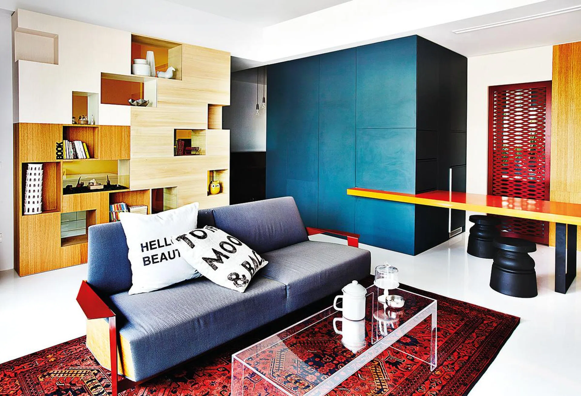 The large Afghan rug, which was bought by Derek in Pakistan, offers an interesting contrast to the contemporary design of the space. Cushions and accessories on table, from Egg3.