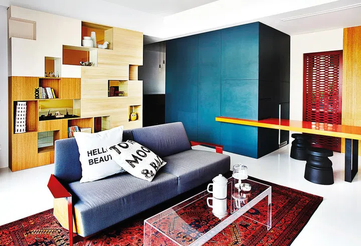 The large Afghan rug, which was bought by Derek in Pakistan, offers an interesting contrast to the contemporary design of the space. Cushions and accessories on table, from Egg3.