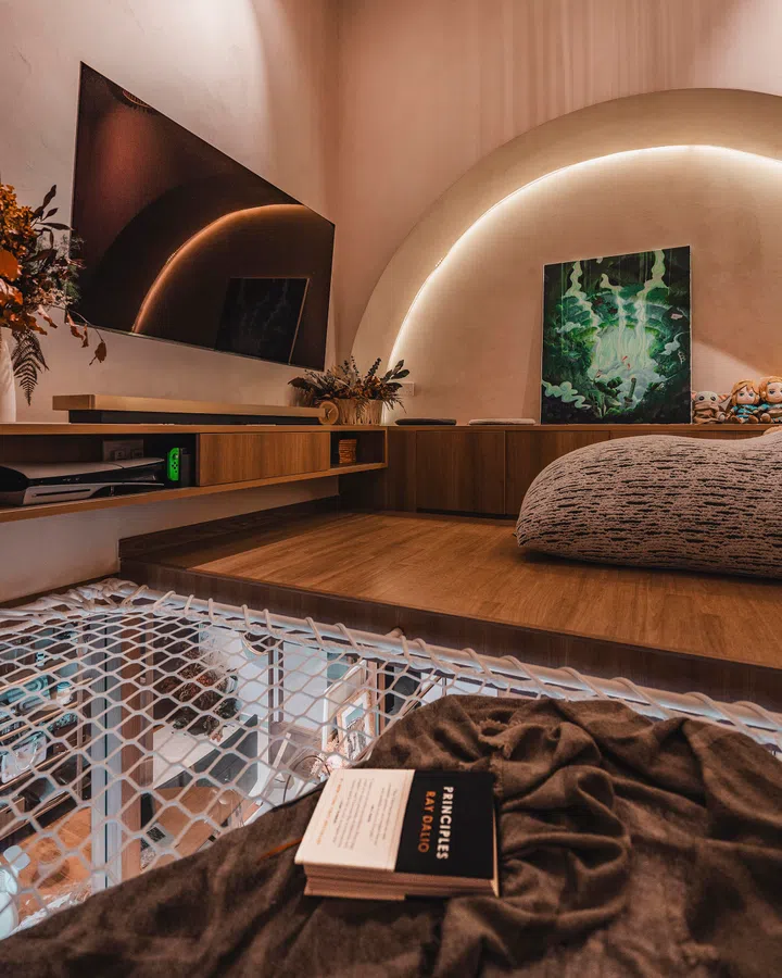 The loft reclaims unused void space, forming a cosy perch for gaming and quiet time