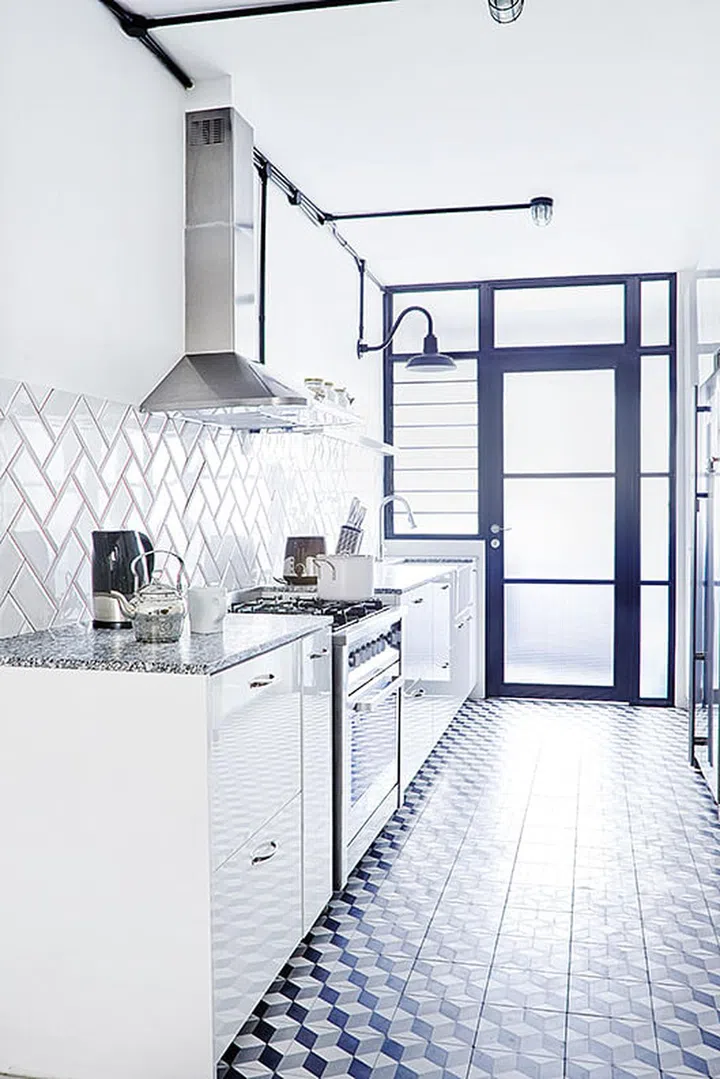 The wall that separated the utility yard from the kitchen was a translucent acrylic door to help bring in more sunlight. Silver tea pot from Egg3. Interior design by JQ Ong The Association