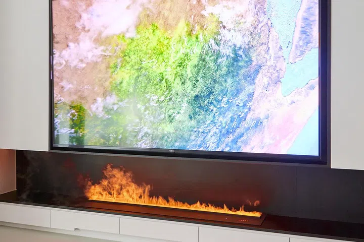 Black and white TV feature wall and the homeowner's Maltese pet dog in a 5-room HDB in Edgedale Plains.