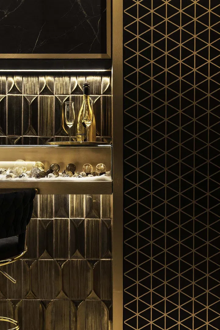 Black and gold glass display for the homeowner's crystal collection in a banking couple's 3-bedroom condominium in West Coast.
