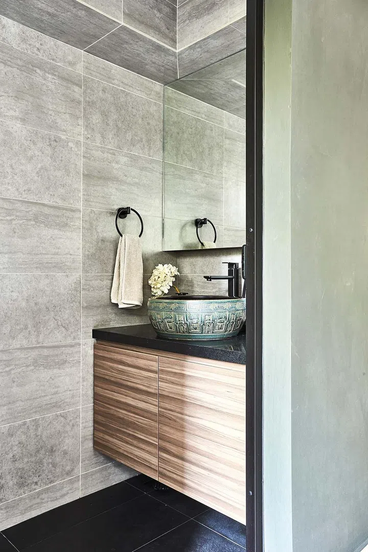 An ornate basin in the powder room adjacent to the kitchen serves as a focal point.