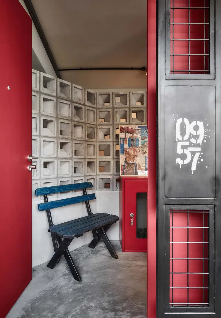 Doorways and frames boast a dramatic apple red colour, balanced with the cool materials like cement.