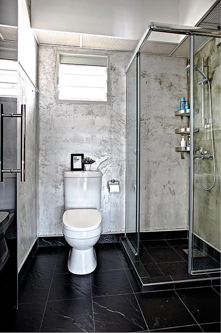 A shower screen was added in the grey-hued bathroom to separate the wet and dry areas.