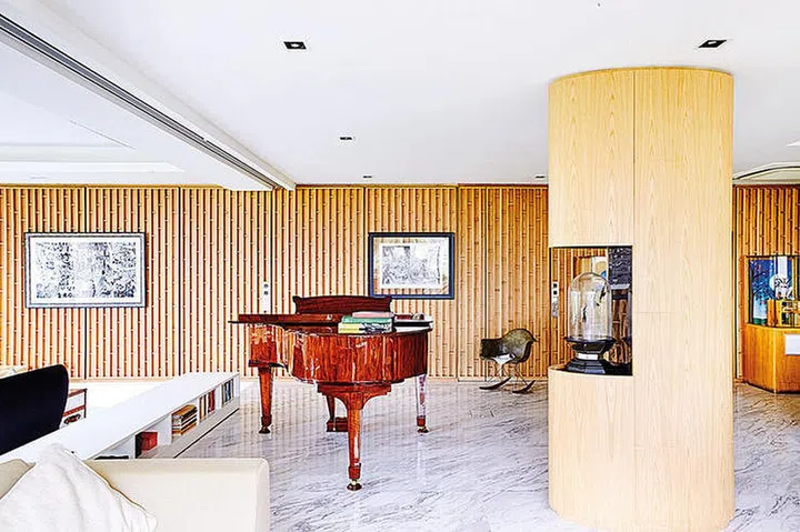 In a darker wood than the rest of the interior, this piano sure stands out! Design by RT + Q Architects