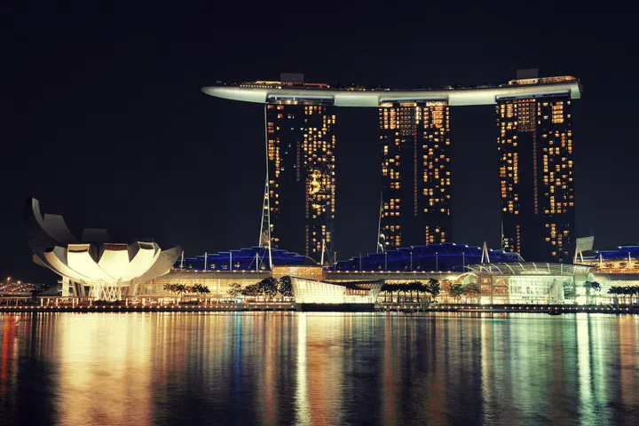SINGAPORE - APR 5: Marina Bay Sands hotel at night on April 5, 2014 in Singapore. It is the world’s most expensive building with cost of US$ 4.7 billion and landmark of Singapore.