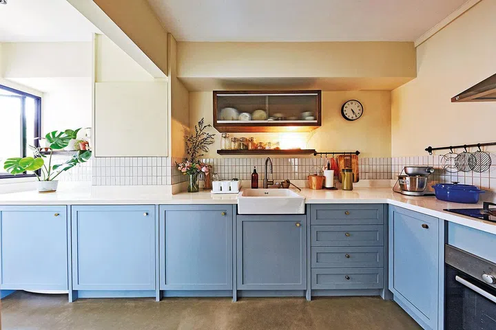 The farmhouse sink and plain mouldings along the cabinetry bring the look of the kitchen together.
