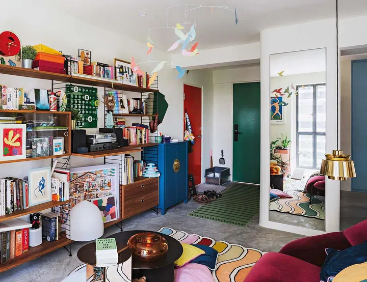 Designer furnishings such as the String Furniture shelves, HAY Slit coffee table, &Tradition Utzon JU1 Brass lamp and Kartell accessories add to the creative vibe.