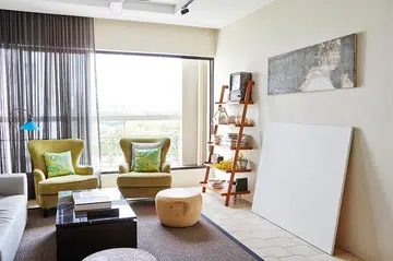 Many furniture pieces were customised, such as the heavy wooden stool and marble-topped coffee table in the light and airy living room.