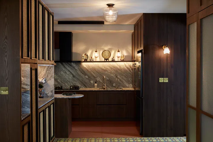 Throughout the home, patterned glass, rattan, and warm veneers reinforce a quiet narrative of cultural inheritance.