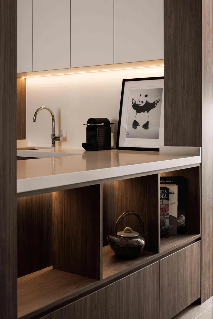 A kitchen island and display storage shelf extends from the kitchen countertop.