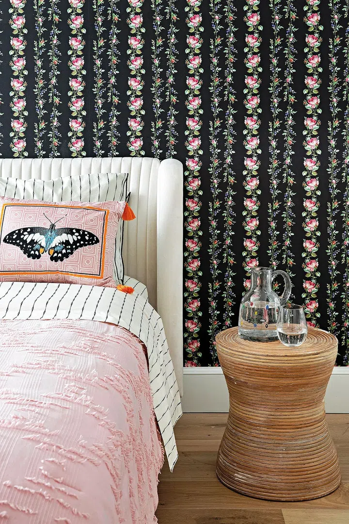 The intricate and colourful wallpaper design in the bedroom is a stark but lovely departure from the stateliness of the common spaces.