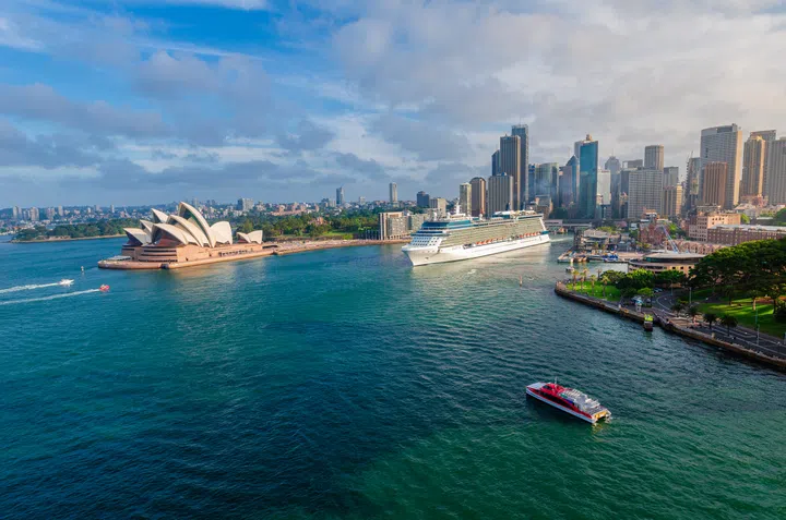 Sydney, Australia - October 26th 2014 : Panoramic drone aerial view over Opera House and Circular Quay. Celebrity Solstice cruise ship is seen leaving the Sydney Harbour, Sydney Australia.