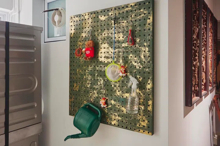 Even utilitarian elements are thoughtfully considered, with a simple pegboard becoming a decorative feature within the renovated kitchen.