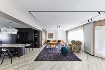 Living room containing an eye-catching La Mamma armchair and footstool from B&B Italia in this HDB executive apartment at Rivervale Plains.