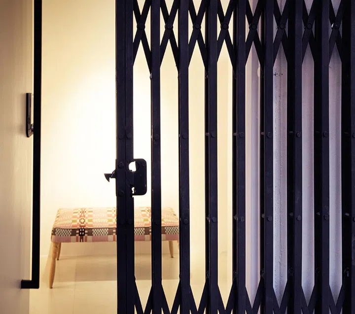 An accordion-style main door gate customised and made in Malaysia to act as a decorative industrial element at the home’s entrance.