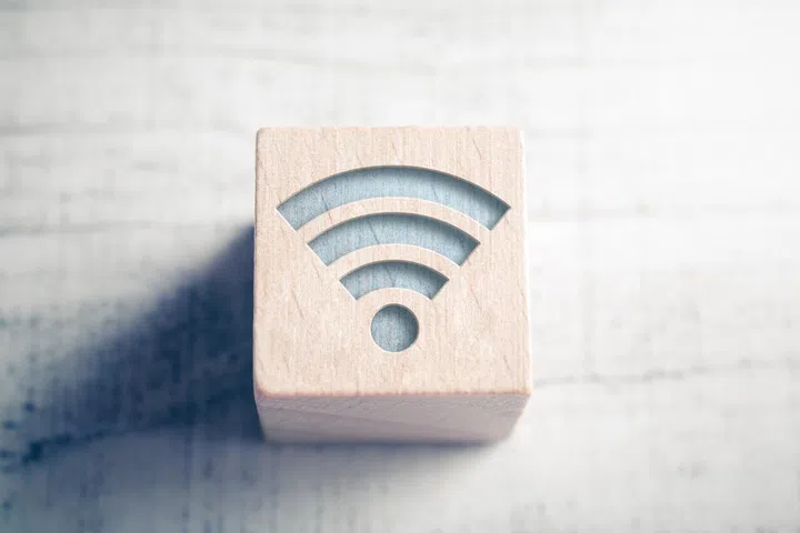 WiFi icon on wooden cube with soft focus background. Internet connection concept.