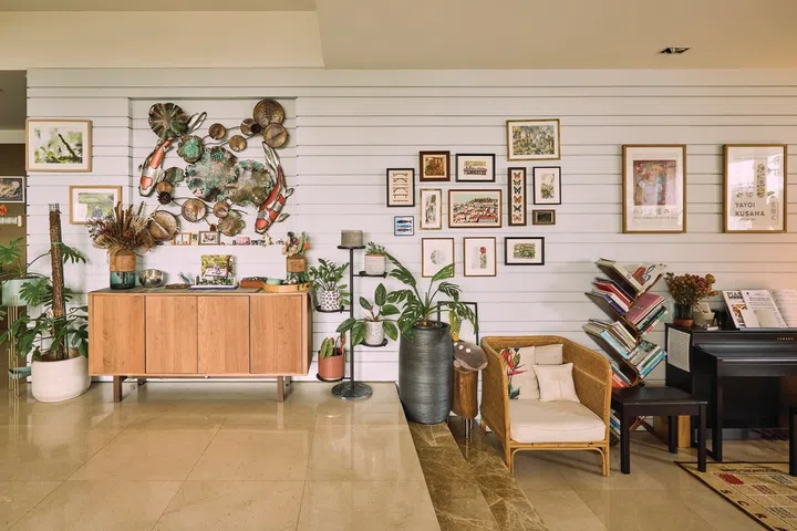A travel wall of memorabilia ranging from Yayoi Kusama exhibition posters to works by street artists and flea market finds.