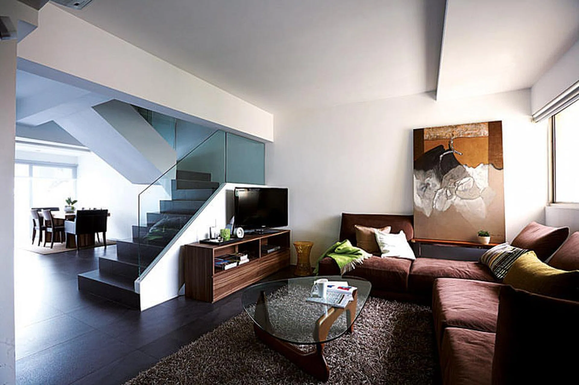 Cement-grey homogeneous tiles add an industrial edge to the neutral, earthy palette of the home.