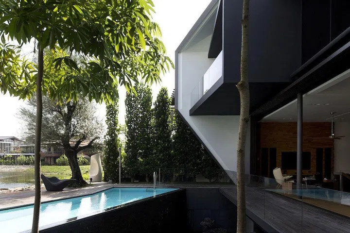 Back of Sentosa’s Diamond House features a private pool, and overlooks a quaint waterway.