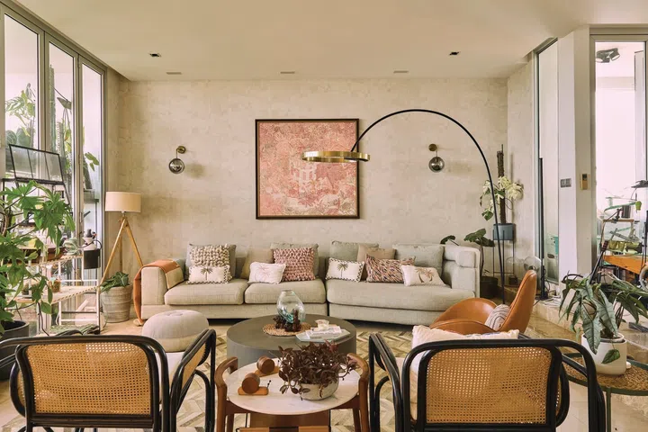 A large Italian sofa in light, neutral colours dominate the living room.