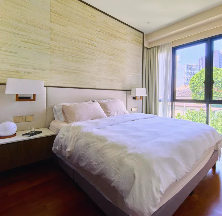 Handwoven textures and subtle silver accents on the bedhead wall bring hotel-style sophistication to the space.