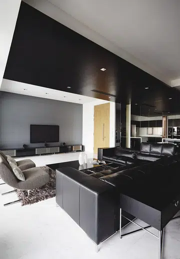 Textured wallcoverings complement the grey granite wall opposite in this dark modern 4-bedroom condominium in Sentosa Cove.